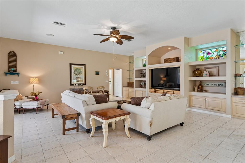 10120 Shortleaf Court Weeki Wachee, FL 34613 - Photo 17 of 95 a living room with furniture a flat screen tv and a fireplace
