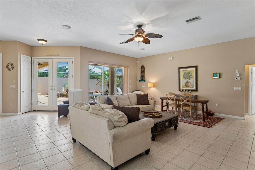 10120 Shortleaf Court Weeki Wachee, FL 34613 - Photo 18 of 95 a living room with furniture and a chandelier