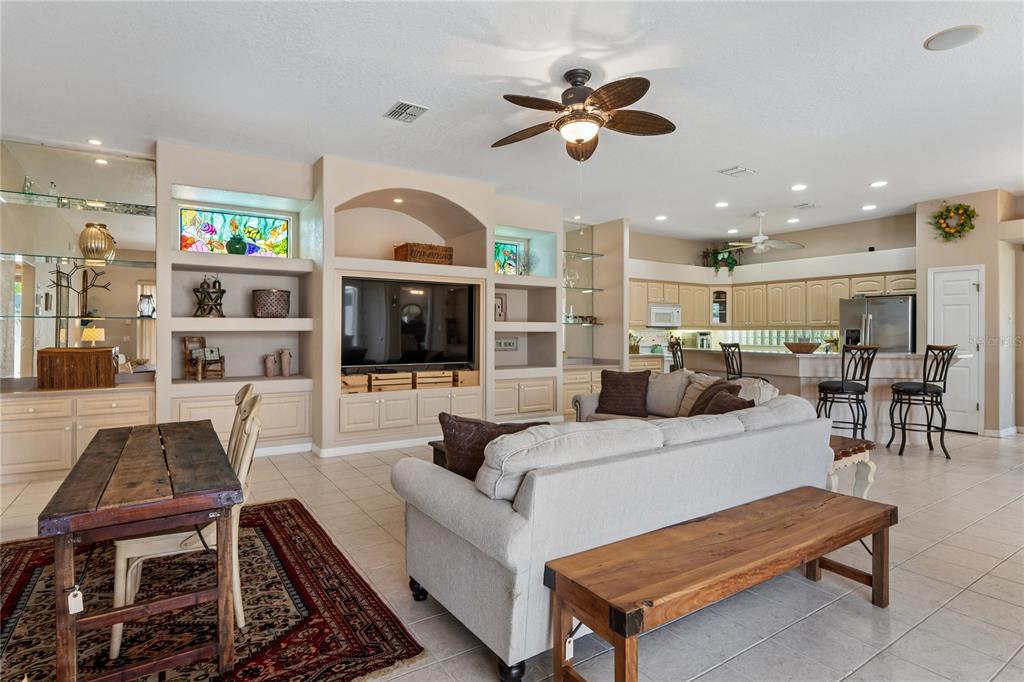 10120 Shortleaf Court Weeki Wachee, FL 34613 - Photo 20 of 95 a living room with furniture kitchen view and a chandelier
