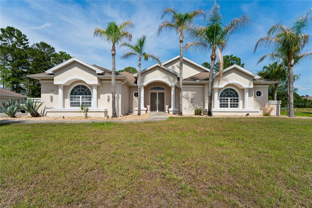 10120 Shortleaf Court Weeki Wachee, FL 34613 - Photo 2 of 95 a front view of a house with garden