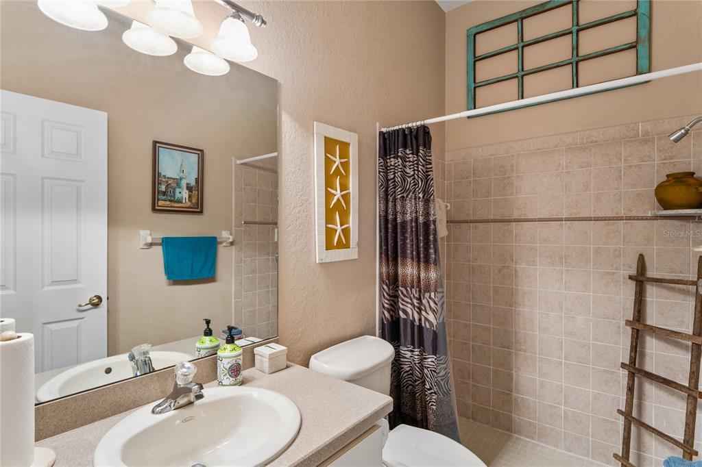 10120 Shortleaf Court Weeki Wachee, FL 34613 - Photo 48 of 95 a bathroom with a sink mirror toilet and shower