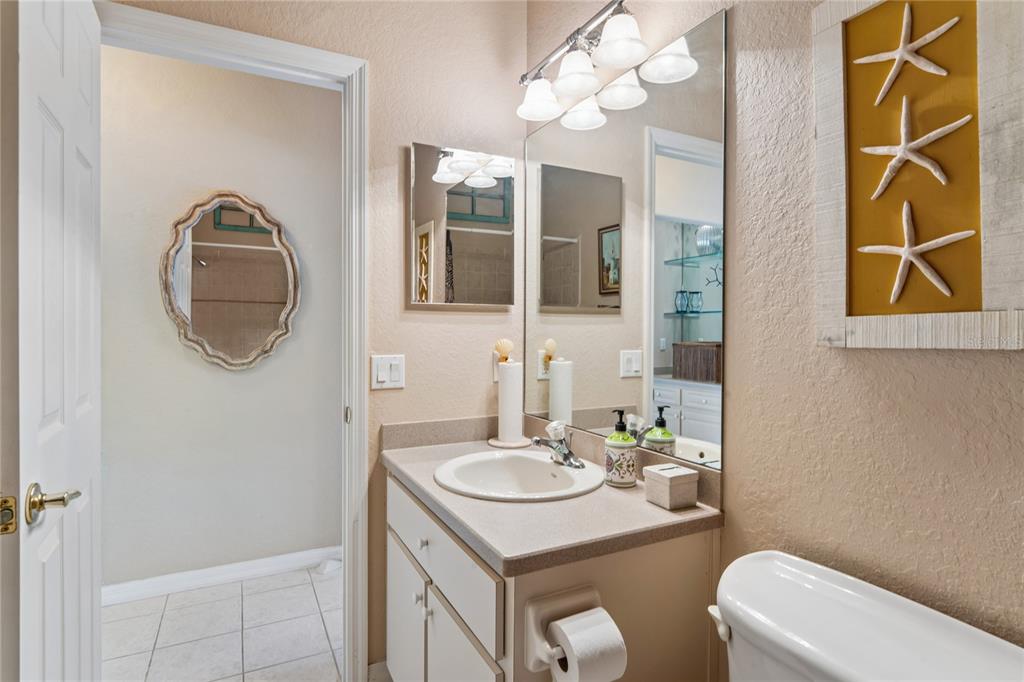 10120 Shortleaf Court Weeki Wachee, FL 34613 - Photo 50 of 95 a bathroom with a sink vanity mirror and toilet