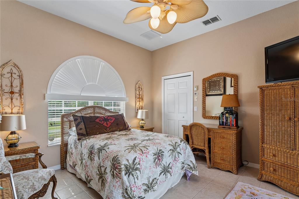 10120 Shortleaf Court Weeki Wachee, FL 34613 - Photo 57 of 95 a bedroom with a bed and a flat tv screen on dresser