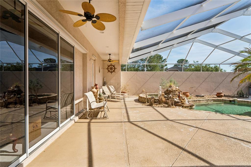 10120 Shortleaf Court Weeki Wachee, FL 34613 - Photo 65 of 95 a view of a patio with a table and chairs