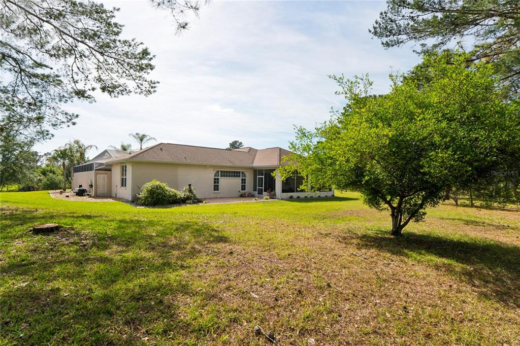 10120 Shortleaf Court Weeki Wachee, FL 34613 - Photo 80 of 95 a front view of a house with yard and lake