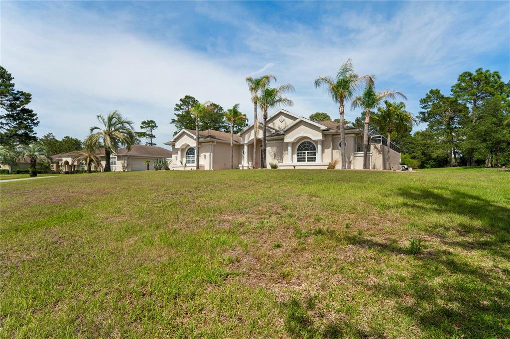 10120 Shortleaf Court Weeki Wachee, FL 34613 - Photo 90 of 95 a front view of a house with a yard