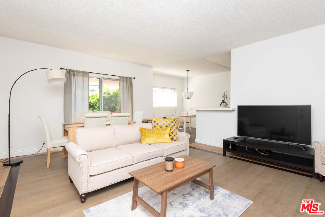 5403 Newcastle Avenue, Unit 69 Encino, CA 91316 - Photo 1 of 34 a living room with furniture and a flat screen tv