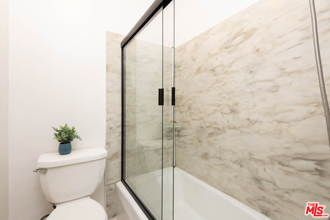 5403 Newcastle Avenue, Unit 69 Encino, CA 91316 - Photo 11 of 34 a bathroom with a toilet and a shower