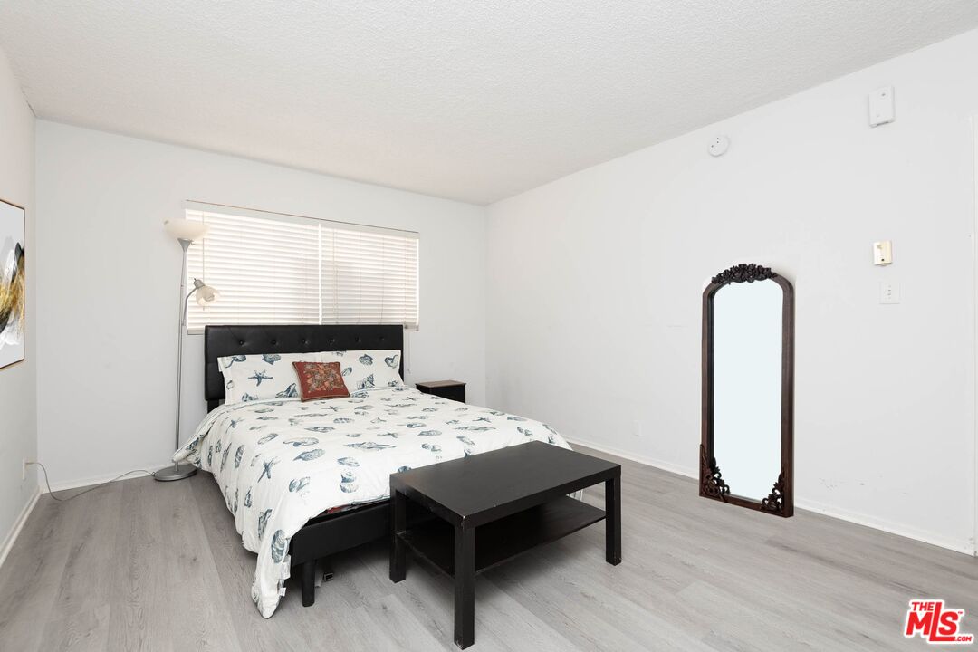 5403 Newcastle Avenue, Unit 69 Encino, CA 91316 - Photo 13 of 34 a bedroom with a bed and a dresser