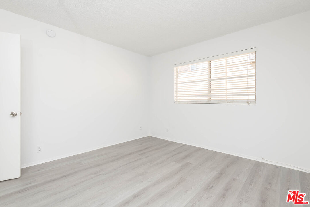 5403 Newcastle Avenue, Unit 69 Encino, CA 91316 - Photo 18 of 34 an empty room with wooden floor and windows