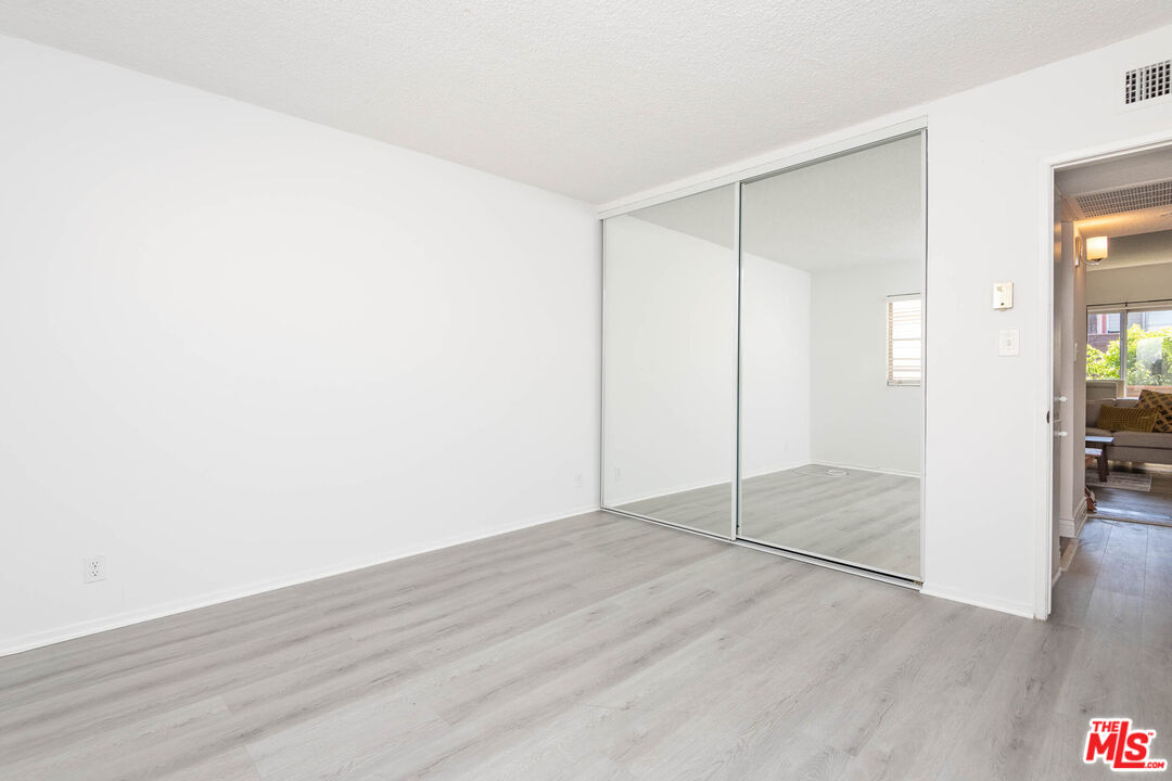 5403 Newcastle Avenue, Unit 69 Encino, CA 91316 - Photo 19 of 34 a view of an empty room with wooden floor and a bathroom