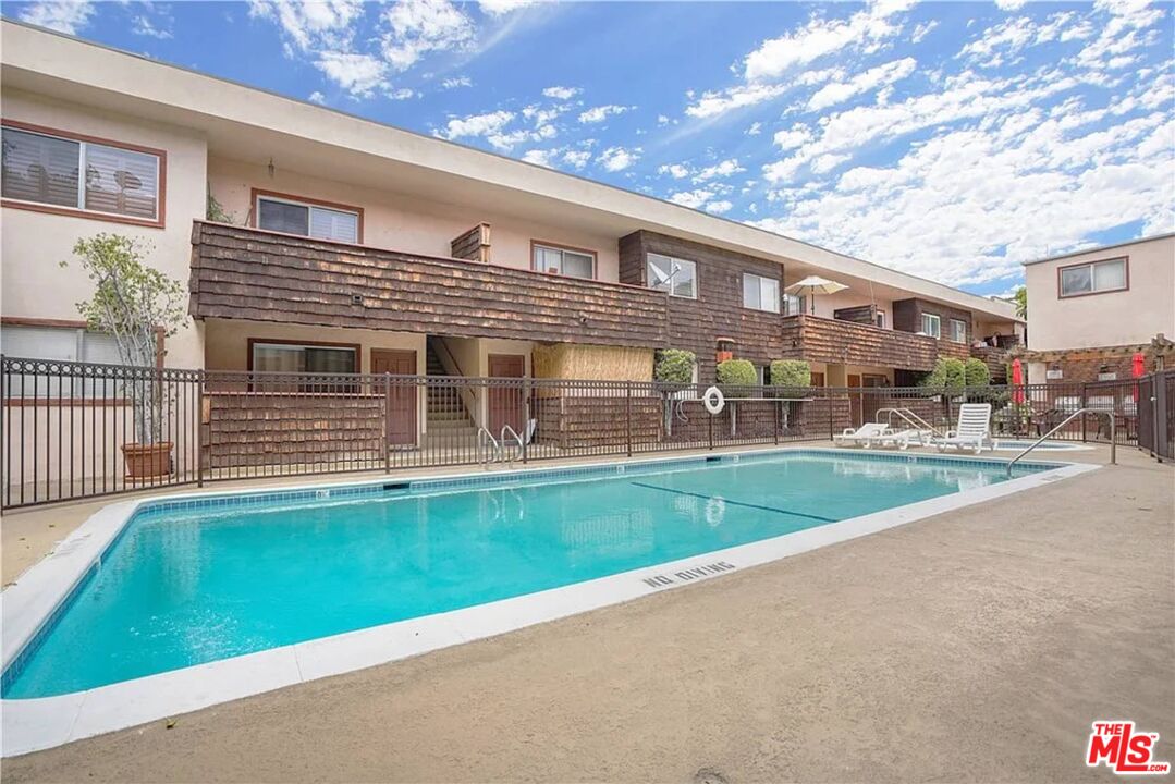 5403 Newcastle Avenue, Unit 69 Encino, CA 91316 - Photo 28 of 34 a front view of a house with a yard garden and outdoor seating