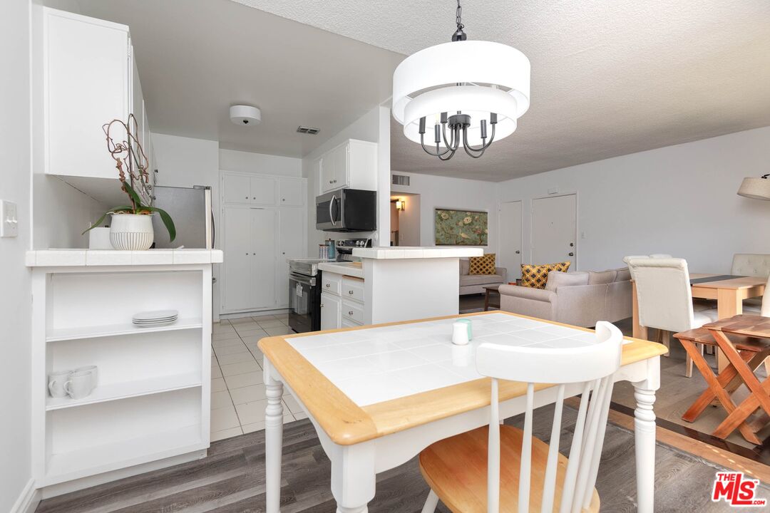 5403 Newcastle Avenue, Unit 69 Encino, CA 91316 - Photo 4 of 34 a view of a dining room with furniture and a chandelier