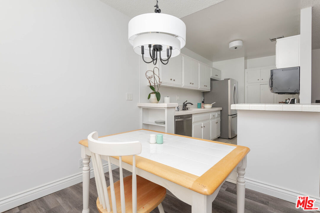 5403 Newcastle Avenue, Unit 69 Encino, CA 91316 - Photo 5 of 34 a kitchen with stainless steel appliances a stove a sink island and a refrigerator