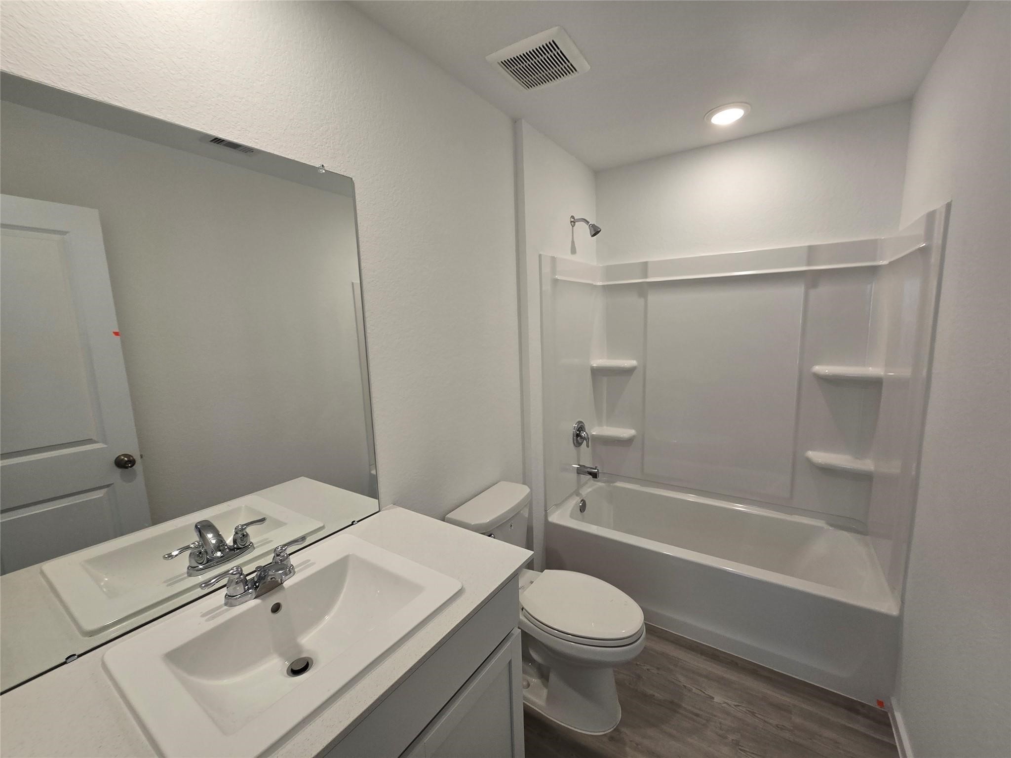 6147 Cherry Ripe Lane Katy, TX 77493 - Photo 7 of 23 a bathroom with a sink toilet and shower