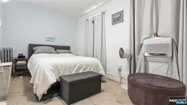 a bedroom with a bed and a mirror