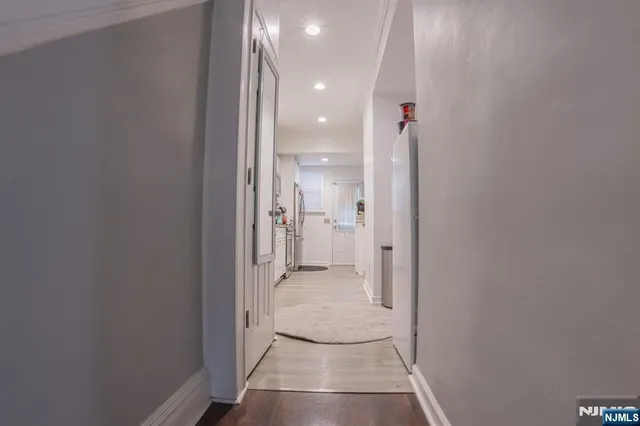 a view of a hallway with wooden shelves