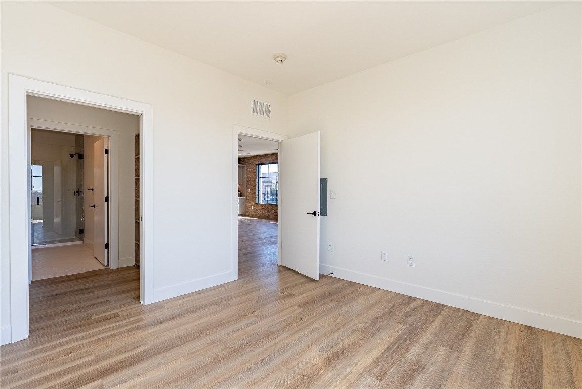 4315 South Congress Avenue, Unit 504 Austin, TX 78745 - Photo 11 of 21 Spare room featuring light wood-type flooring
