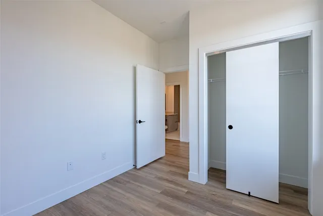 a view of an empty room with wooden floor