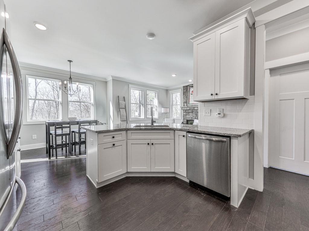 711 Carver Mill Road Talking Rock, GA 30175 - Photo 20 of 39 a kitchen with granite countertop white cabinets a sink a window and stainless steel appliances