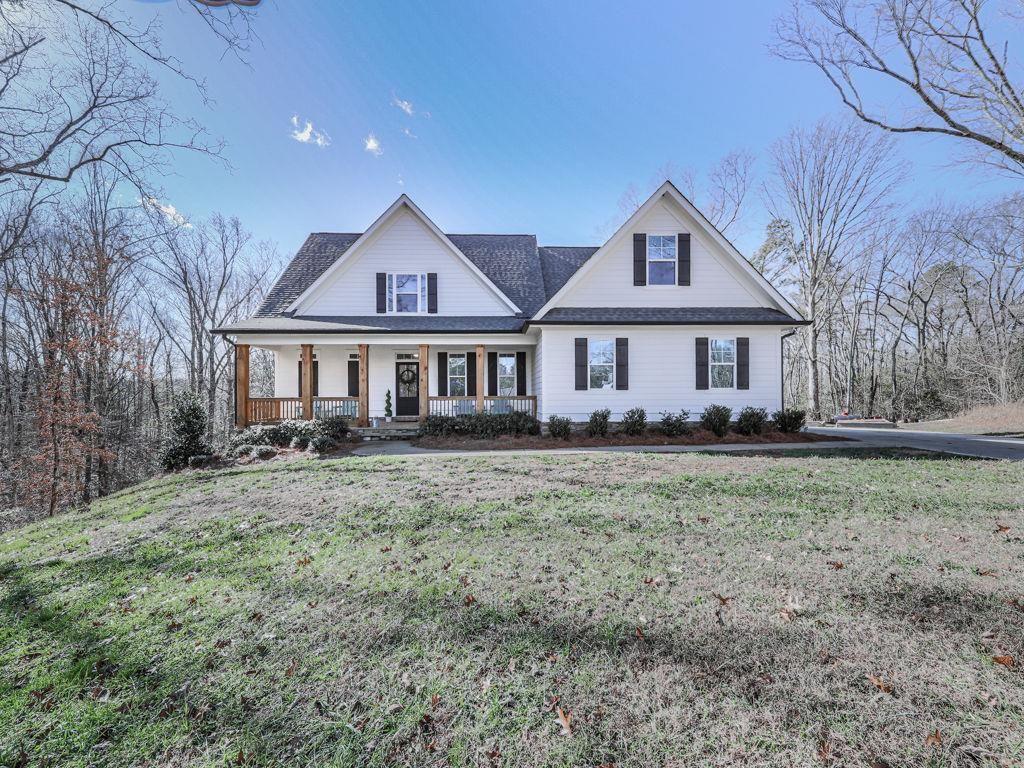 711 Carver Mill Road Talking Rock, GA 30175 - Photo 2 of 39 a front view of a house with a garden
