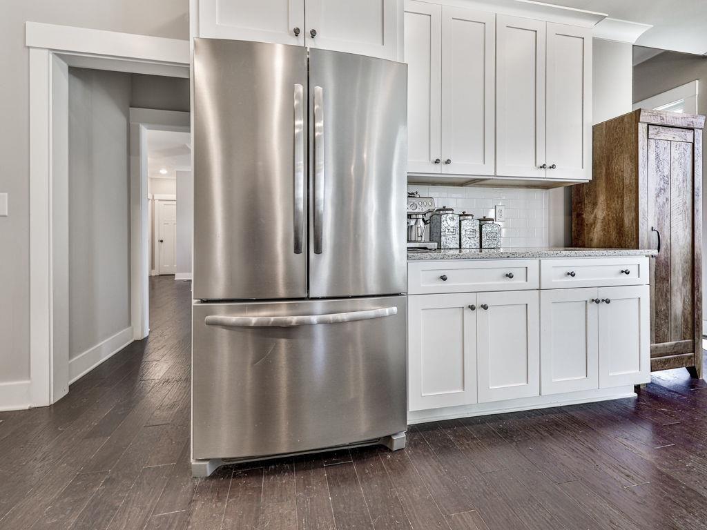 711 Carver Mill Road Talking Rock, GA 30175 - Photo 22 of 39 a kitchen with stainless steel appliances white cabinets and wooden floor