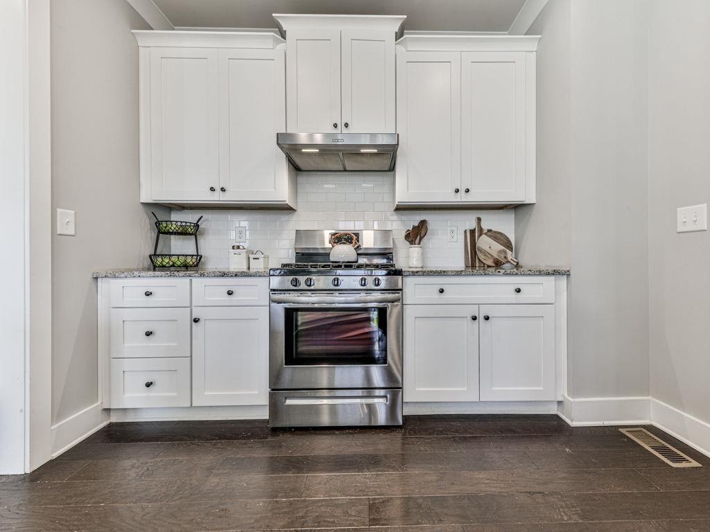 711 Carver Mill Road Talking Rock, GA 30175 - Photo 23 of 39 a kitchen with white cabinets and white appliances