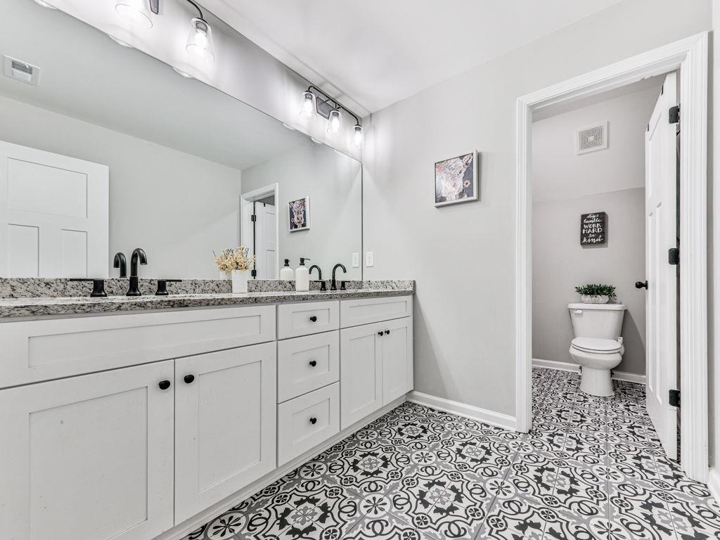 711 Carver Mill Road Talking Rock, GA 30175 - Photo 26 of 39 a bathroom with a sink a toilet and a mirror