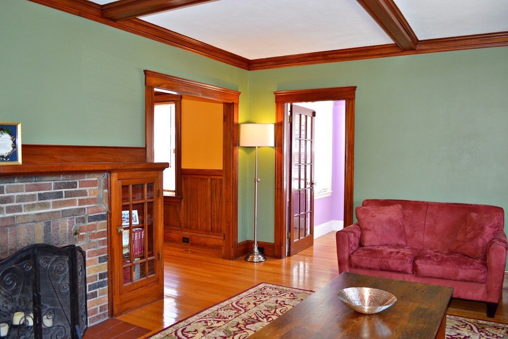 10 Caltha Road Boston, MA 02135 - Photo 3 of 30 a living room with furniture a fireplace and wooden floor