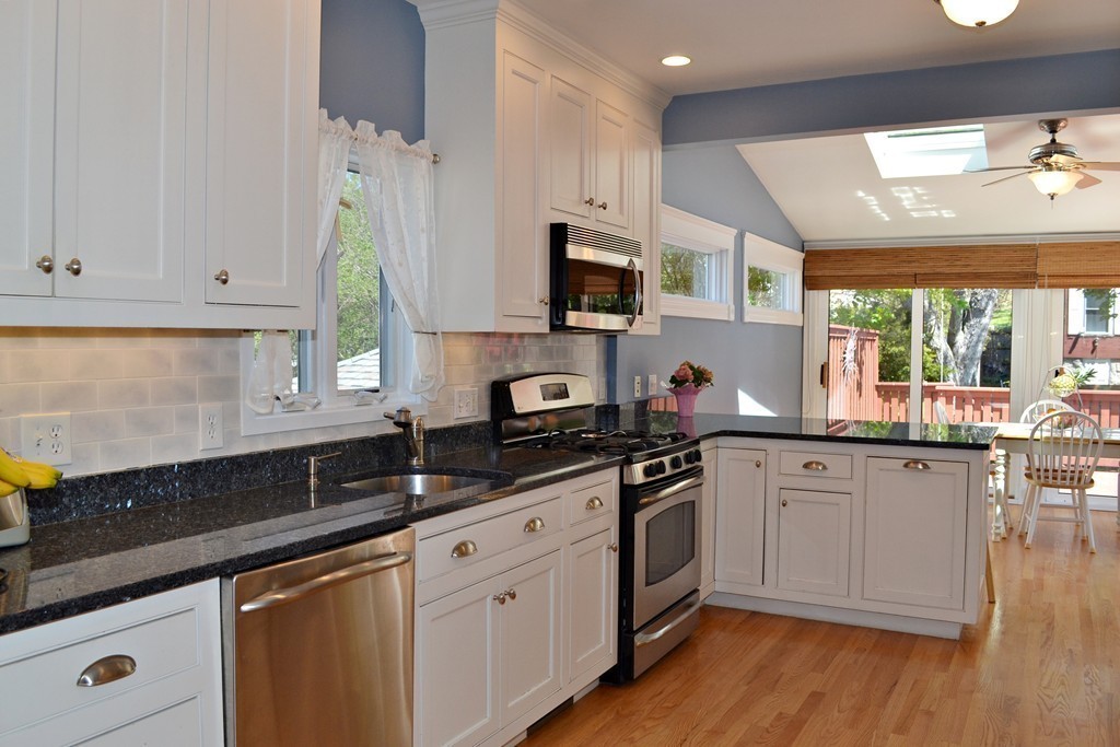 10 Caltha Road Boston, MA 02135 - Photo 8 of 30 a kitchen with stainless steel appliances granite countertop a sink a stove and cabinets