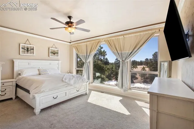 a spacious bedroom with a bed and a large window