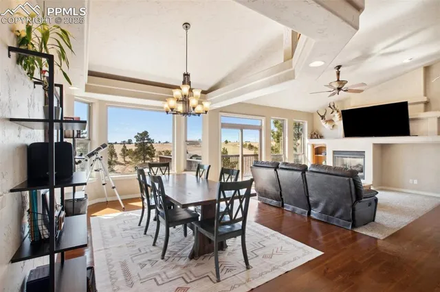 a view of a dining room with furniture wooden floor and chandelier