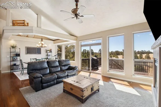 a living room with furniture and a floor to ceiling window