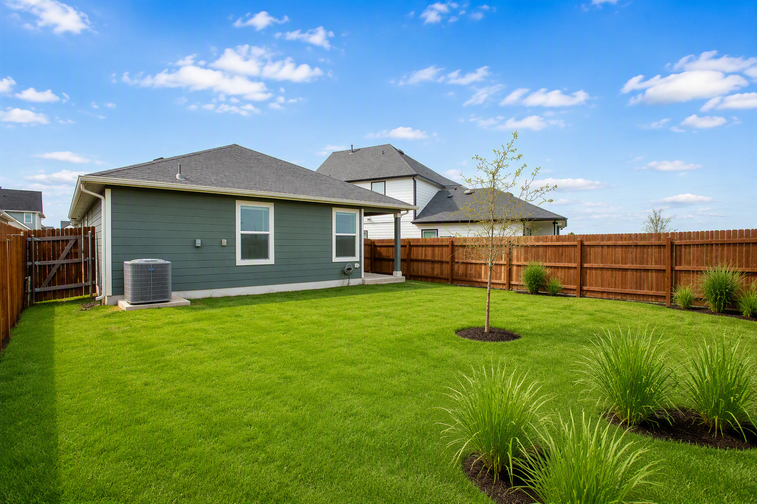 133 Frogmore Loop Kyle, TX 78640 - Photo 19 of 19 A verdant backyard with a wooden privacy fence offers ample space for outdoor living and recreation.