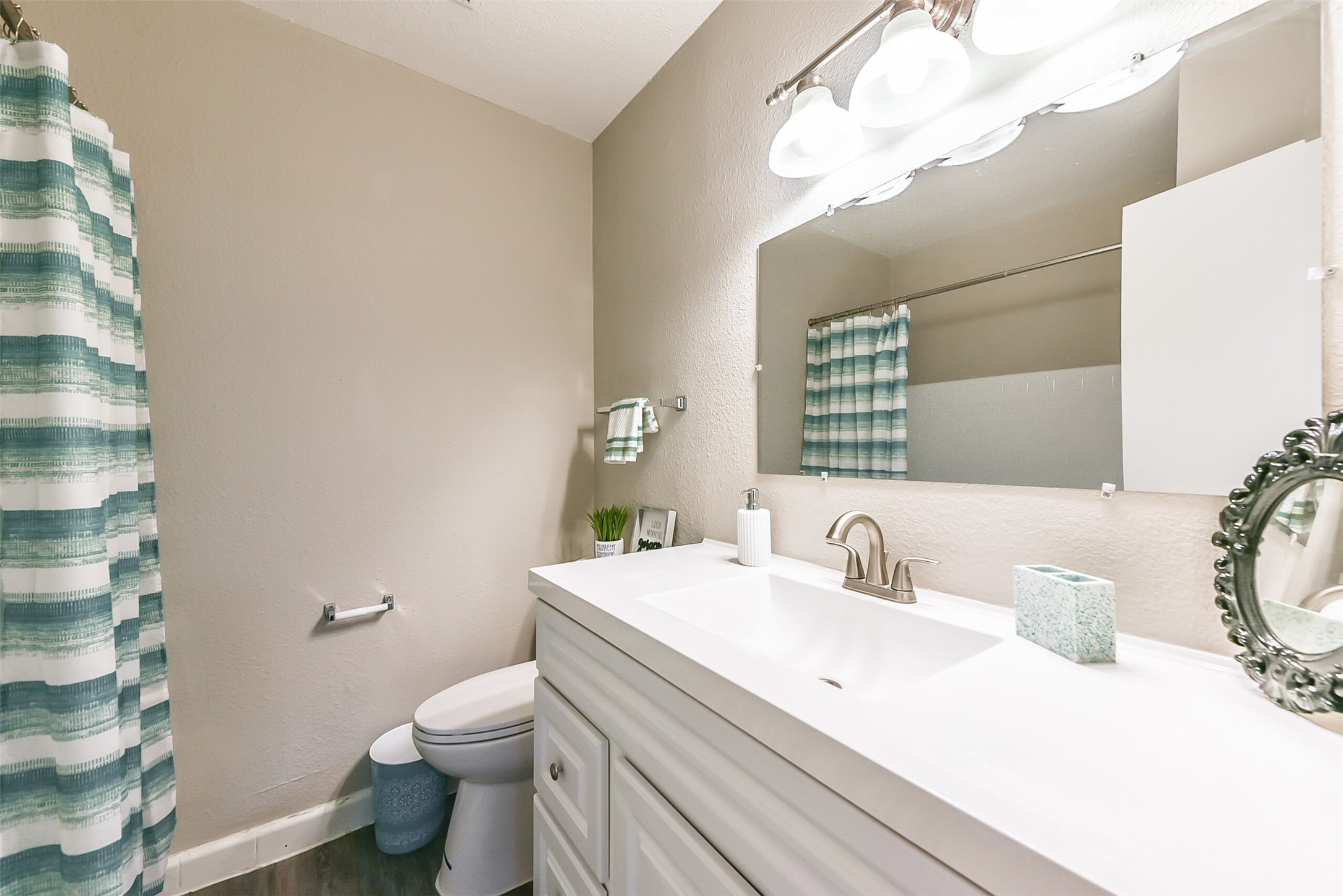 8271 Stone Street, Unit 7104 Houston, TX 77061 - Photo 17 of 28 a bathroom with a sink a toilet and mirror