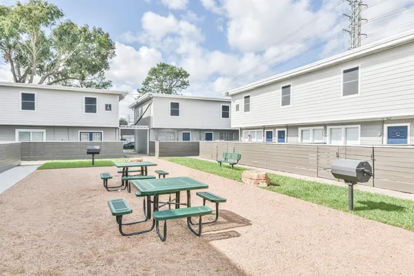 a swimming pool with outdoor seating and yard