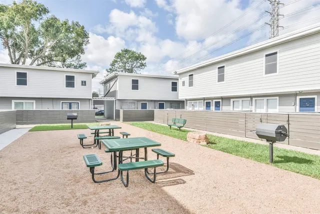 a swimming pool with outdoor seating and yard