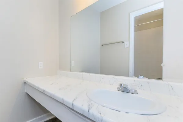 an empty room with chandelier fan