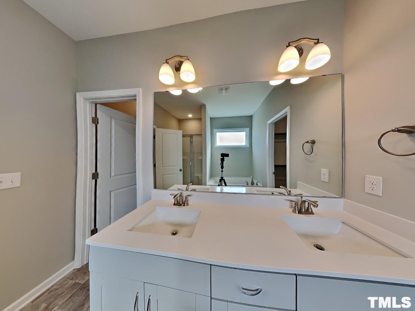 106 Two Daughters Streme Smithfield, NC 27577 - Photo 6 of 16 a bathroom with a sink a light fixture and a mirror