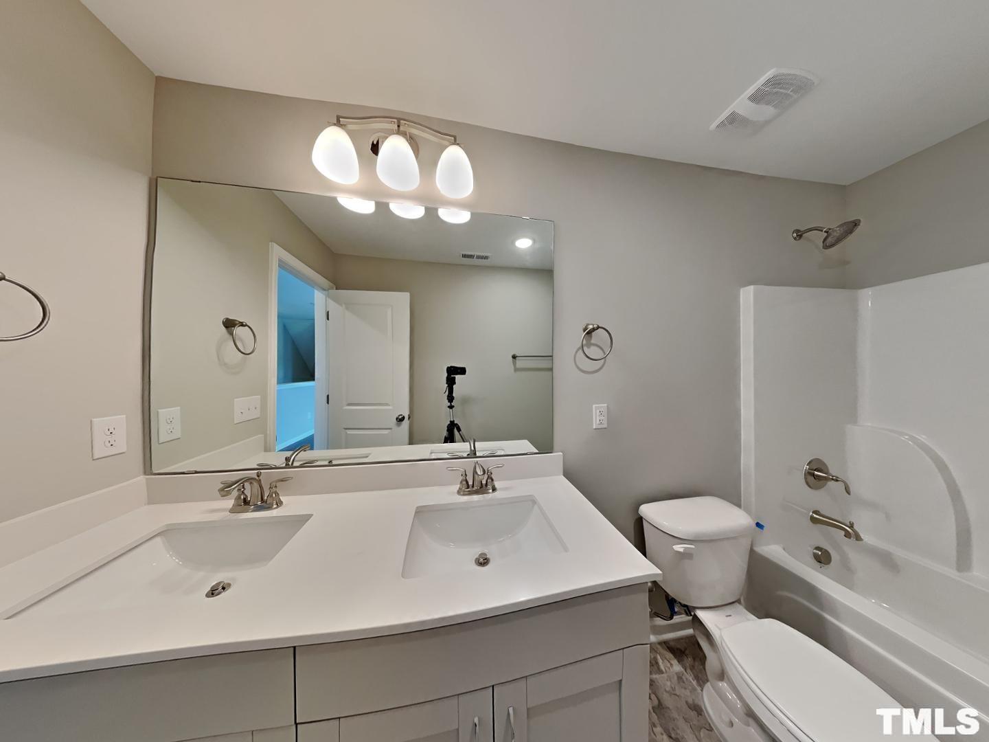 106 Two Daughters Streme Smithfield, NC 27577 - Photo 10 of 16 a bathroom with a sink and a mirror