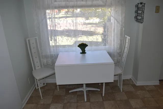 a dining room with furniture and window