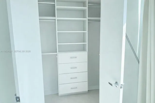 a view of a hallway with paintings on the wall