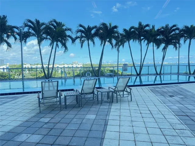 front view of a house with a yard and potted plants