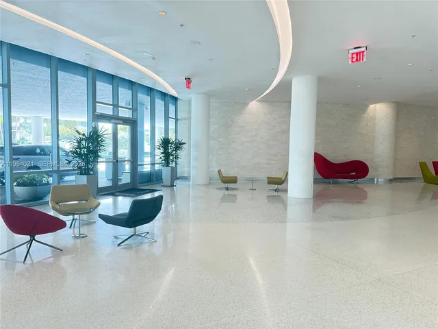 a view of a room with gym equipment and floor to ceiling window