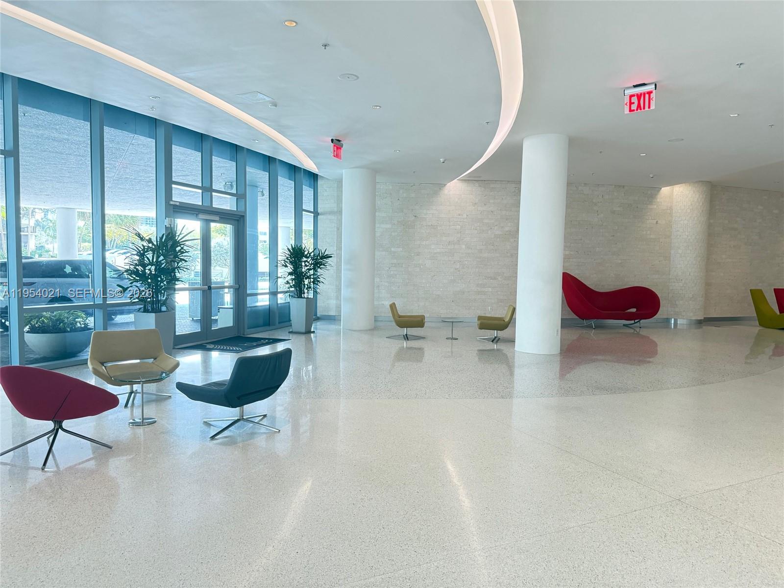 601 Northeast 36th Street, Unit 1112 Miami, FL 33137 - Photo 22 of 32 a living room with furniture and a floor to ceiling window