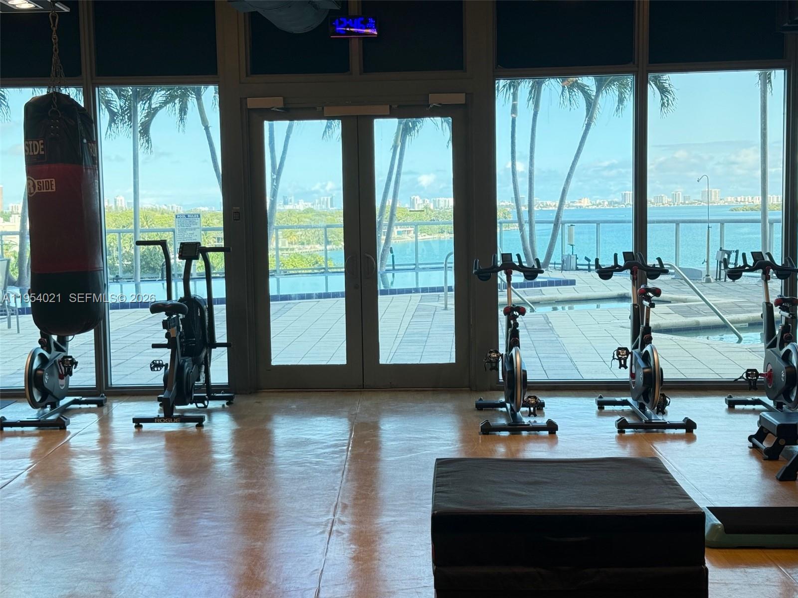 601 Northeast 36th Street, Unit 1112 Miami, FL 33137 - Photo 26 of 32 a view of a room with gym equipment and floor to ceiling window