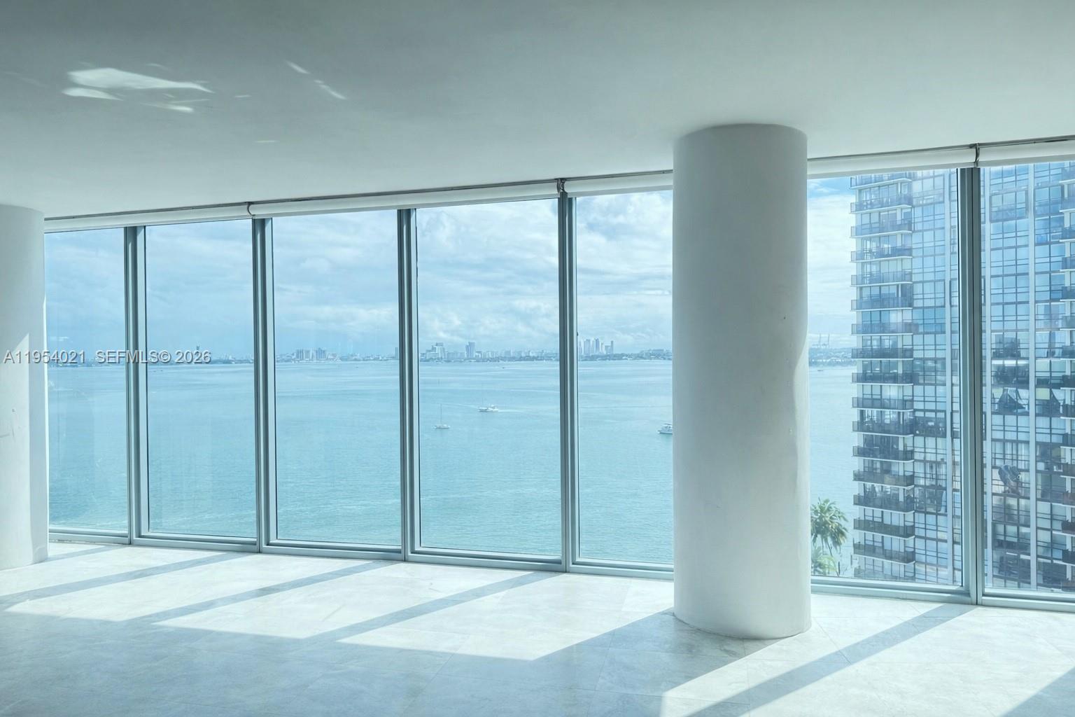 601 Northeast 36th Street, Unit 1112 Miami, FL 33137 - Photo 3 of 32 an empty room with sliding door