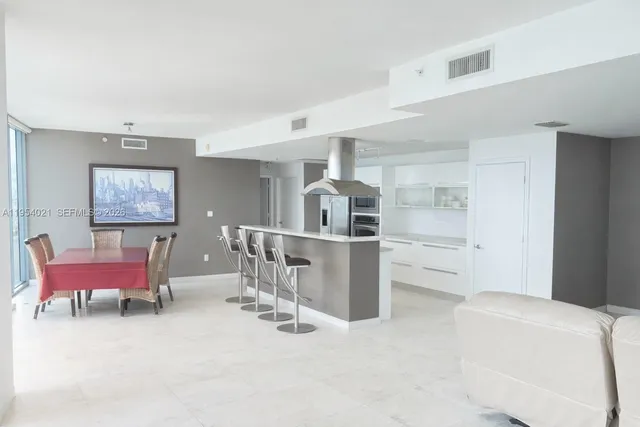 a kitchen with a refrigerator and a stove