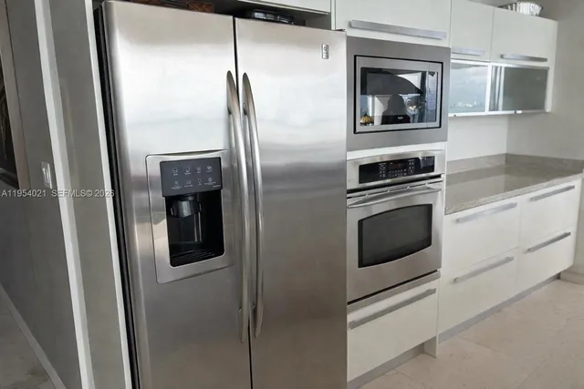 a bedroom with a large bed and a large window
