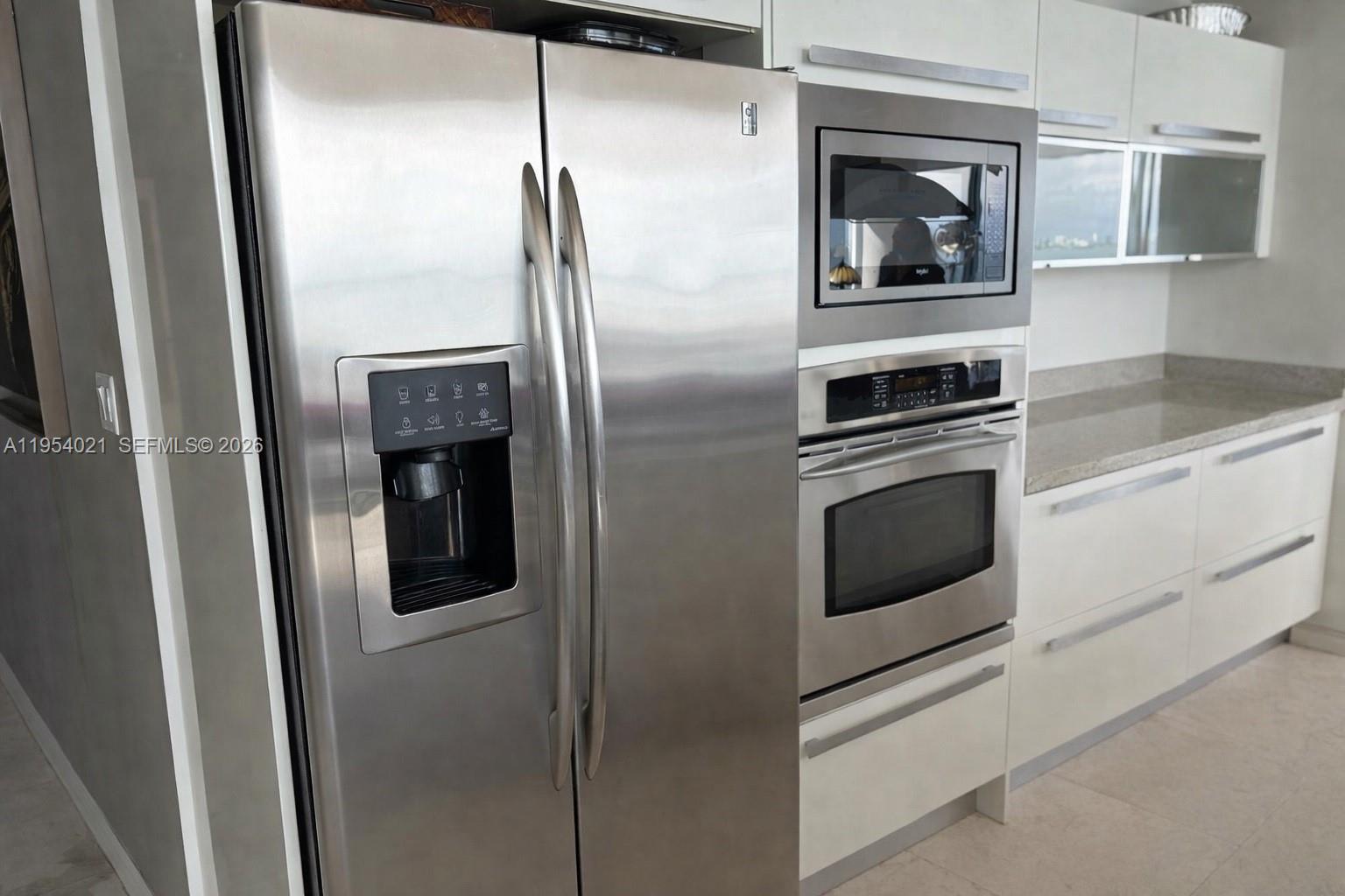 601 Northeast 36th Street, Unit 1112 Miami, FL 33137 - Photo 5 of 32 a kitchen with a refrigerator and a stove